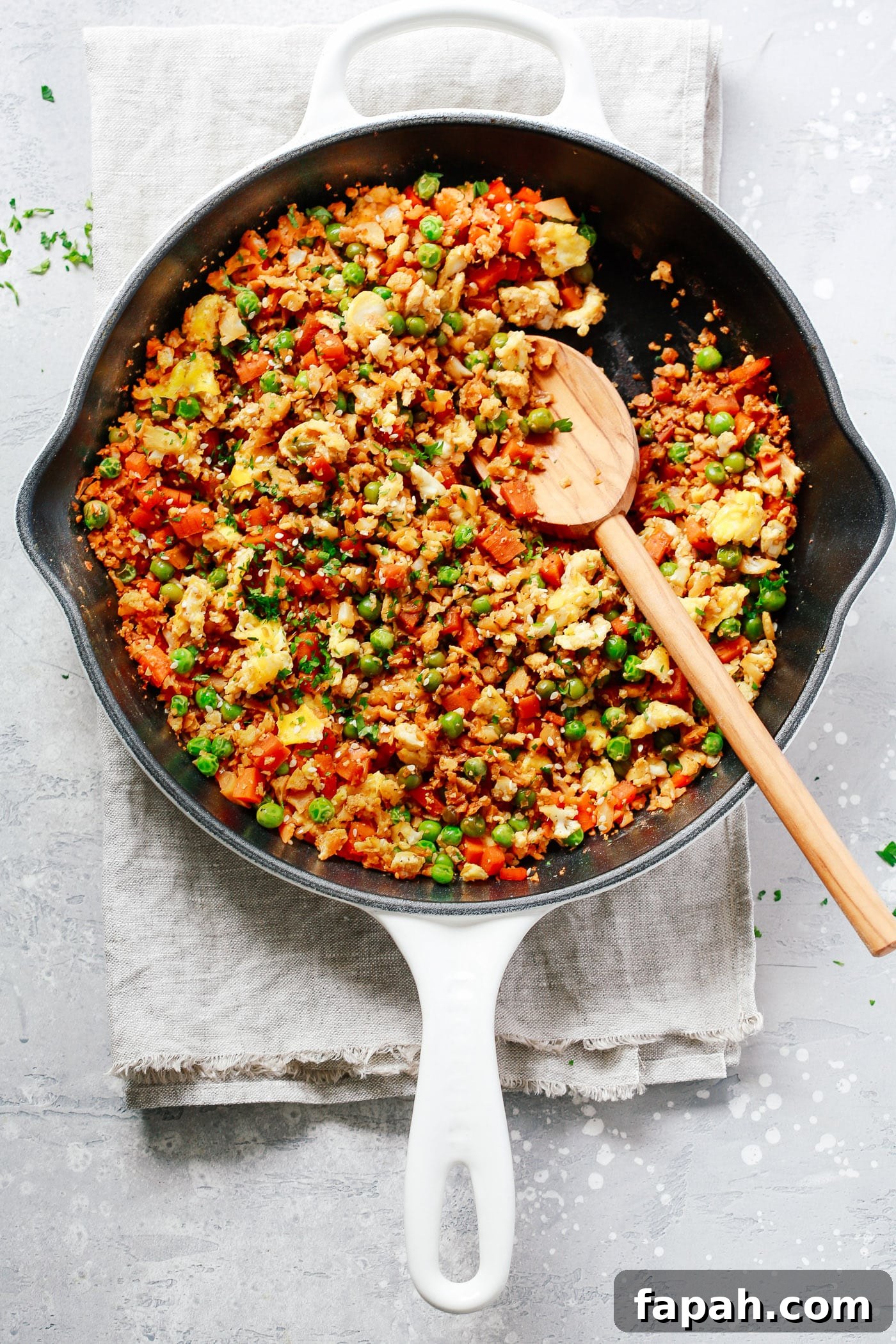 60 Delicious Whole30 Recipes for Every Meal and Snack 10 close up of a cast iron skillet containing fried cauliflower rice