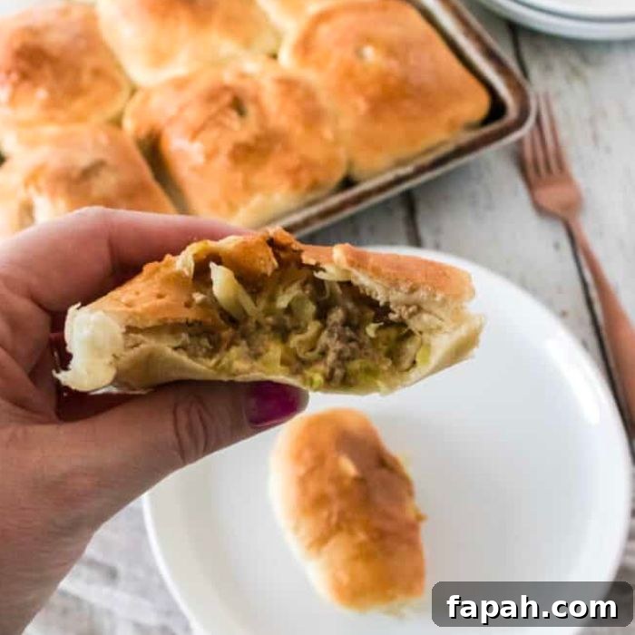 Quick Bierocks Made with Frozen Dinner Rolls: Simple Weeknight Recipe 2 bierock in hand with half cut open showing the filling