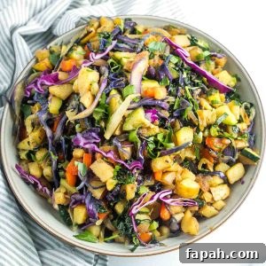 Chopped potatoes mixed in with colorful veggies like kale, red pepper, purple cabbage and zucchini for a colorful veggie hash.