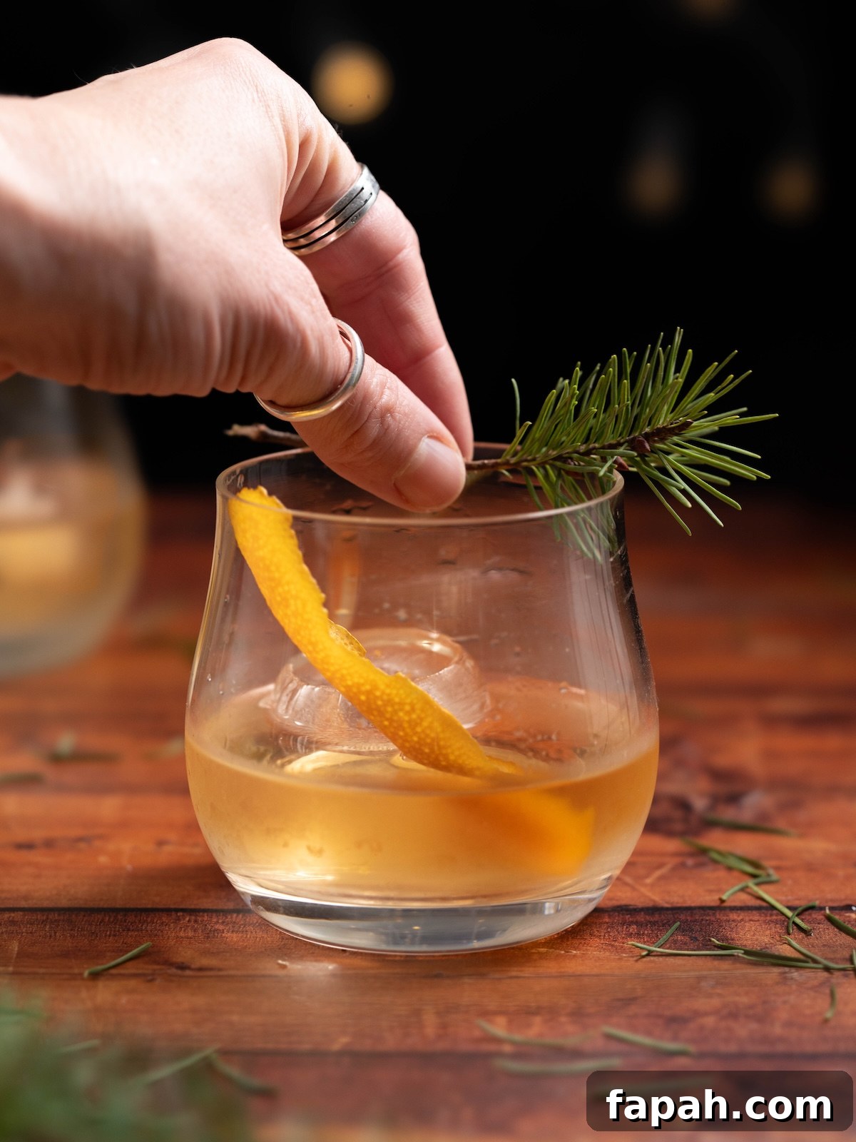 Pine Needle Old-Fashioned Cocktail Recipe Guide 5 Garnishing a Pine Needle Old Fashioned with a Douglas fir twig
