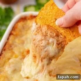 dipping a chip into cream cheese bean dip