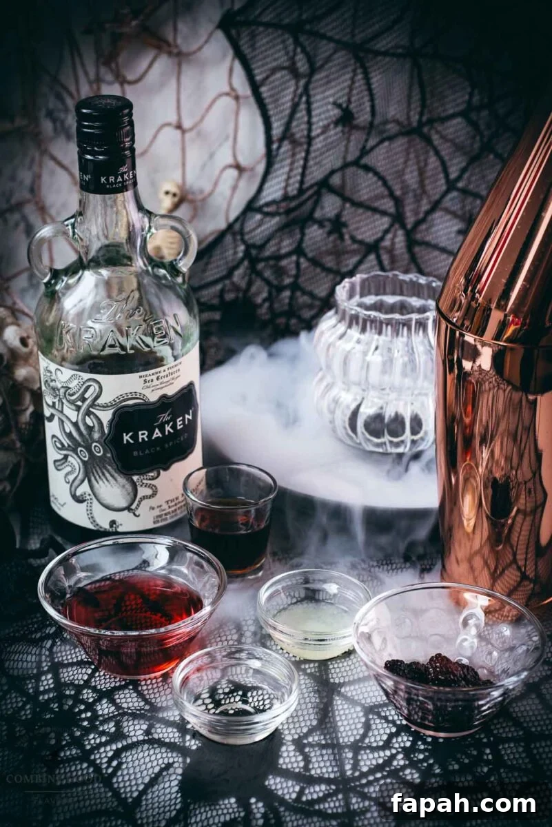 Ingredients for a Kramble Halloween cocktail - cranberry juice, lemon juice, sugar syrup, The Kraken black spiced rum, blackberries, and crushed ice.