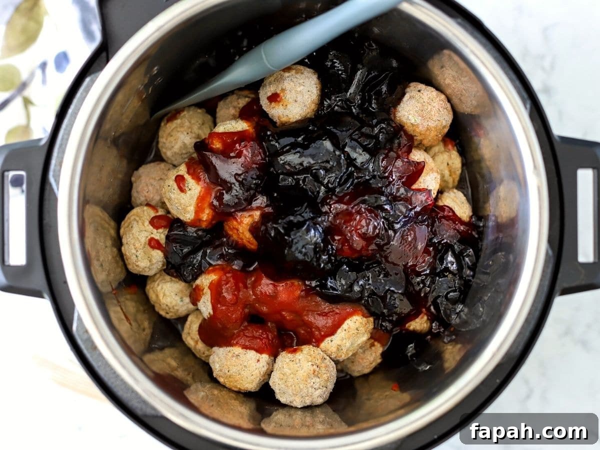 Instant Pot Grape Jelly Meatballs Recipe for Quick Weeknights 4 frozen meatballs, chili sauce, and grape jelly in the instant pot.