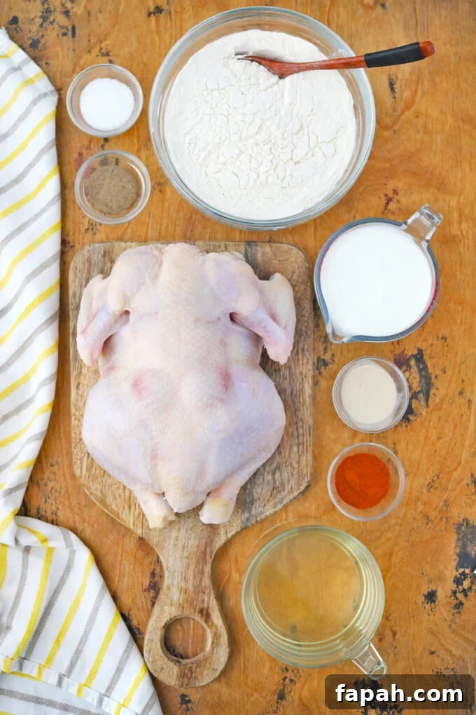Crispy Southern-Style Fried Chicken Recipe for Perfect Crunch 4 Overhead shot of homemade fried chicken ingredients on a wooden table.