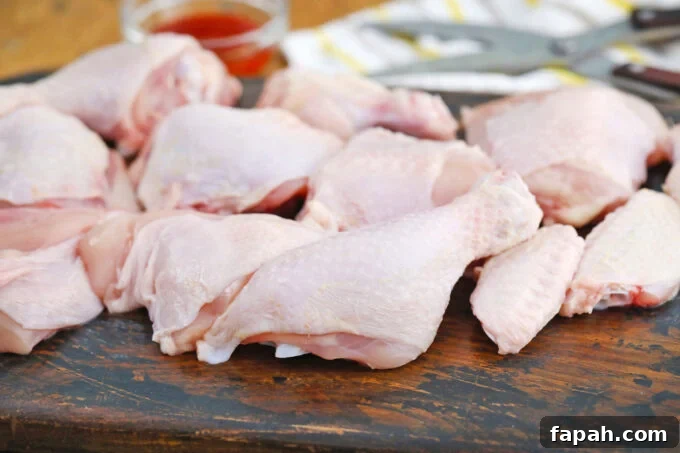 Crispy Southern-Style Fried Chicken Recipe for Perfect Crunch 5 Chicken pieces on a cutting board.
