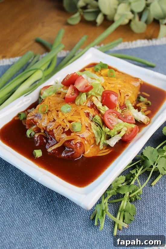 A tortilla filled with beef, topped with fresh chopped green onions and tomatoes.