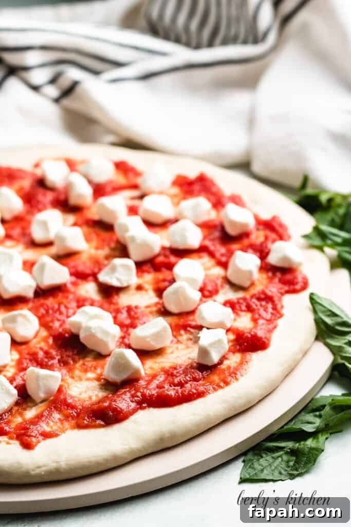 Fresh pearls of mozzarella have been added to the pie.