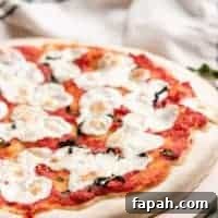 The pizza has cooked and is ready to slice.