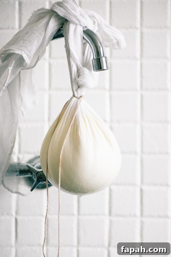 Yoghurt hanging in muslin from an old kitchen tap.
