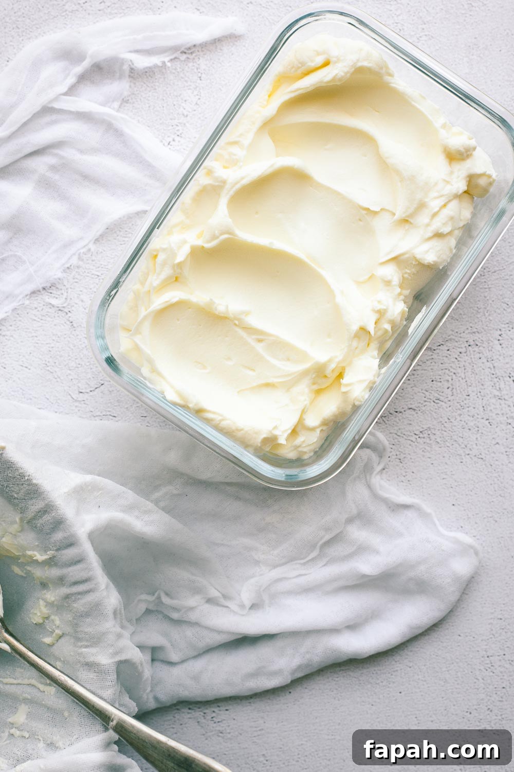 Labneh in a glass container ready to be stored.