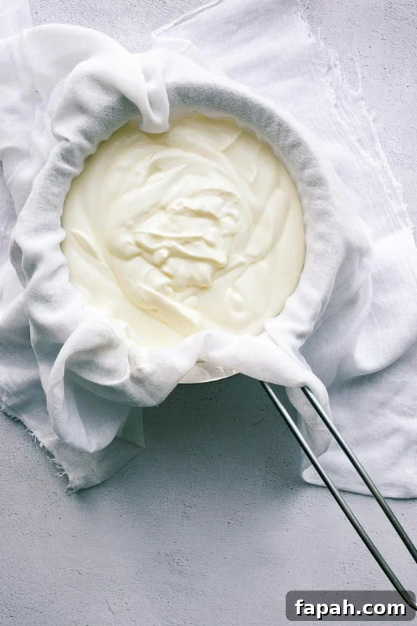 Yoghurt in a muslin-lined sieve.
