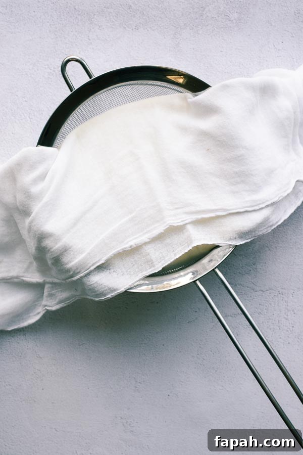 Making labneh at home with a sieve and muslin.