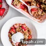 35 Gluten-Free Valentine’s Day Desserts to Delight Your Loved One 19 Strawberry crisp in bowl with ice cream on top.