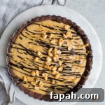 35 Gluten-Free Valentine’s Day Desserts to Delight Your Loved One 20 A frozen pie with a chocolate crust set on a marble round and a gray linen tea towel.