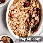 35 Gluten-Free Valentine’s Day Desserts to Delight Your Loved One 21 Fresh cherry crumble in a white dish.