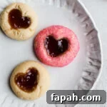 35 Gluten-Free Valentine’s Day Desserts to Delight Your Loved One 23 Heart thumbprint cookies on a white plate.