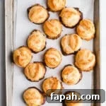 Coconut macaroons on a baking sheet lined with parchment.