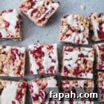 35 Gluten-Free Valentine’s Day Desserts to Delight Your Loved One 37 Raspberry coconut cereal treats on a blue surface.