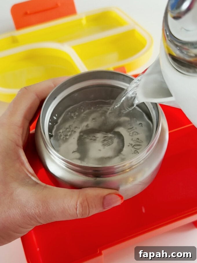 Hot water being poured into the thermos.