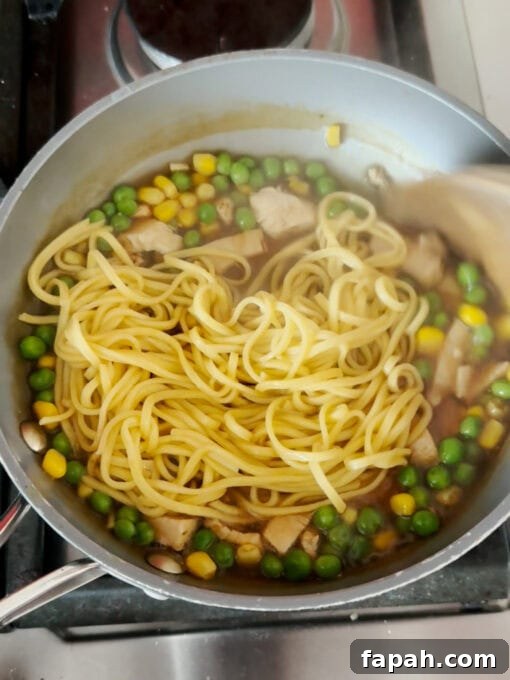 Mixing drained noodles