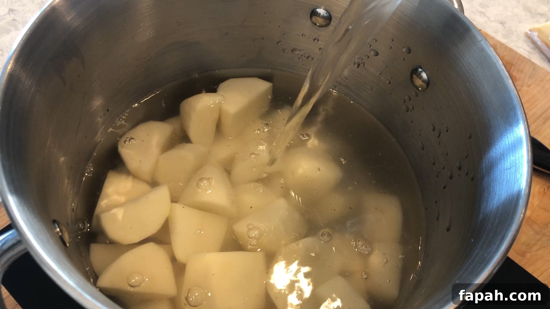 potatoes in a pot being covered by water