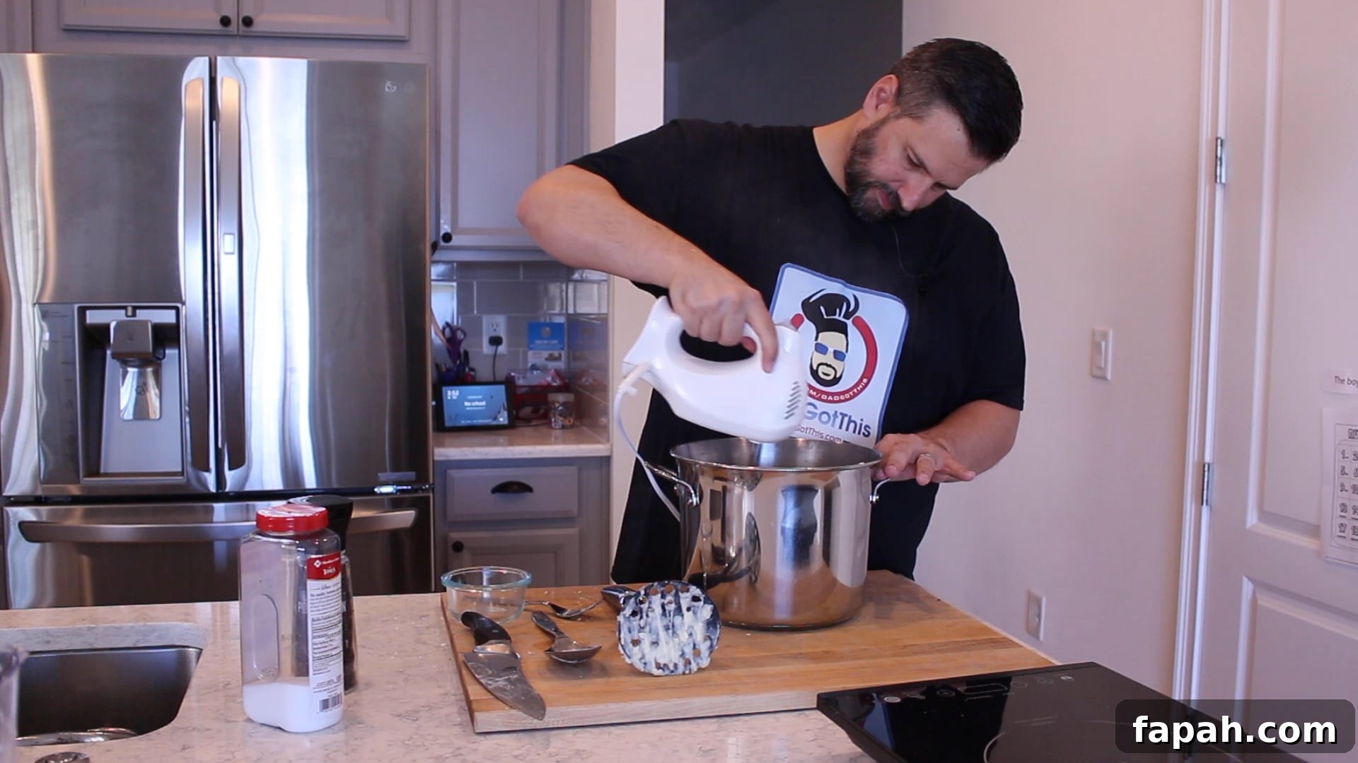 Dad whipping mashed potatoes with a hand mixer