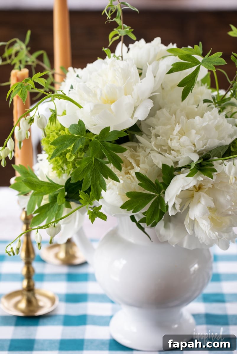 Complete Guide to Flower Arranging: Techniques, Tips & Styles 3 white peonies in a white pitcher.