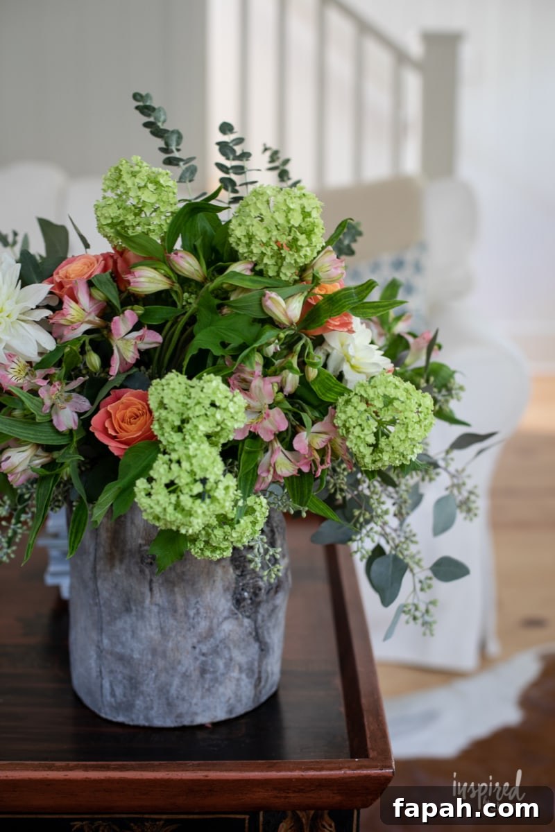 Complete Guide to Flower Arranging: Techniques, Tips & Styles 7 a mix of flowers in a wood trunk vase.