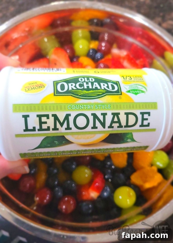 lemonade concentrate over mixed fruit in bowl