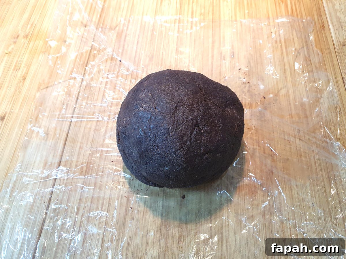 How to Make Homemade Oreo Cookies from Scratch 14 dough ball on cling film, ready to wrap and chill in the fridge.