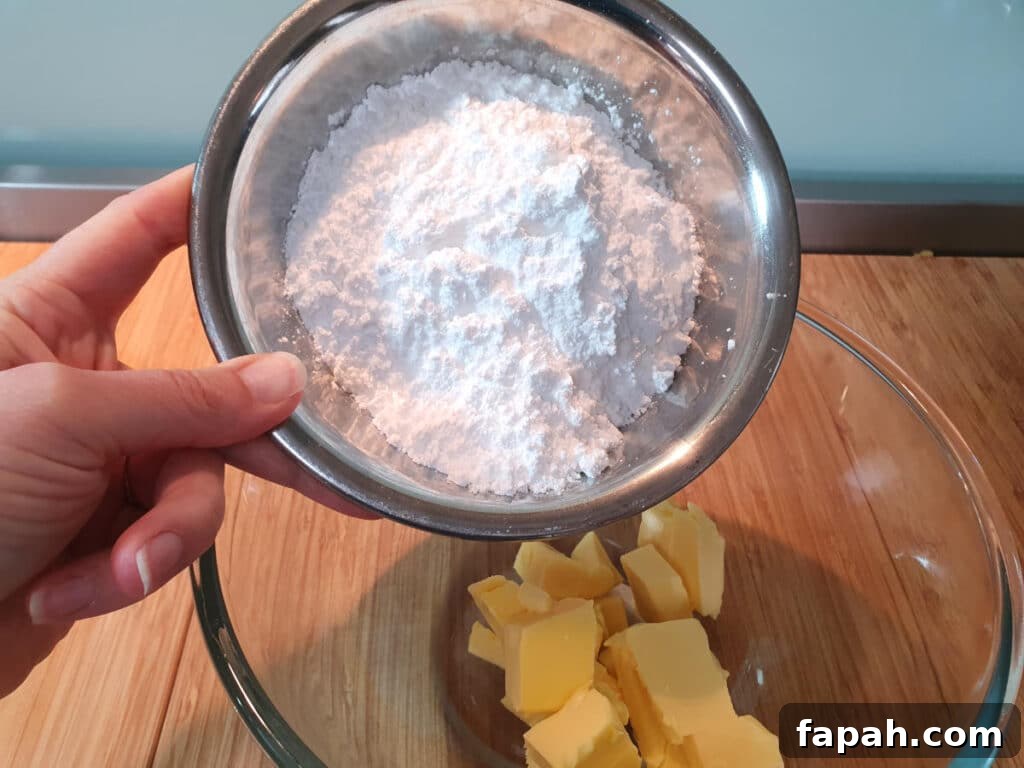 How to Make Homemade Oreo Cookies from Scratch 20 adding icing sugar to chopped butter in mixing bowl.