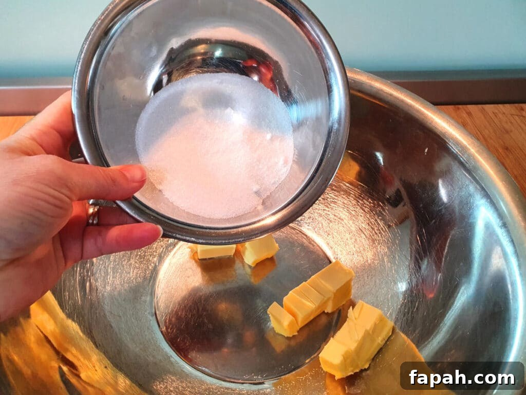 How to Make Homemade Oreo Cookies from Scratch 5 adding white sugar to butting in a large metal bowl.