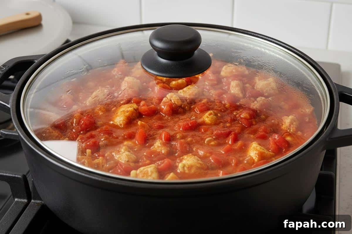 Stirred in the tomatoes and covered the pot.