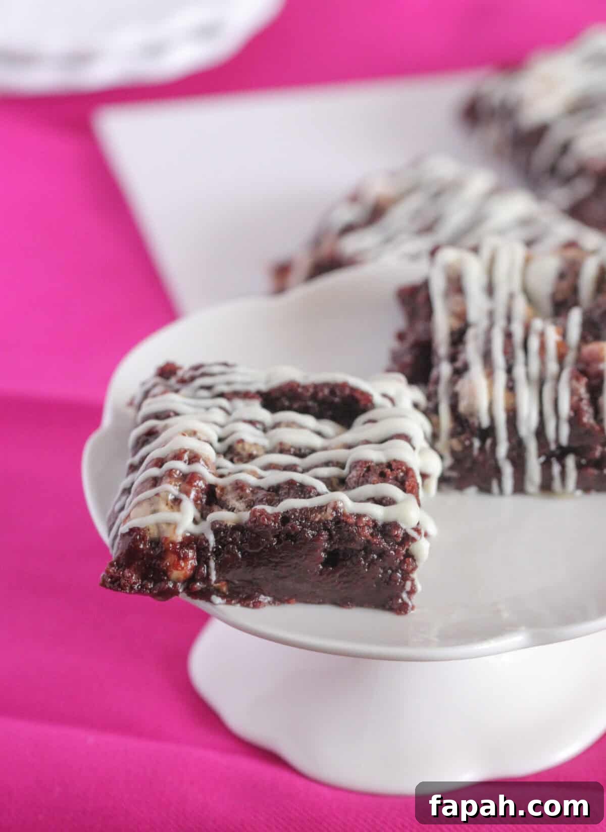 Decadent Caramel Pecan Brownies with Gooey Center 2 square of pecan brownie on cake stand