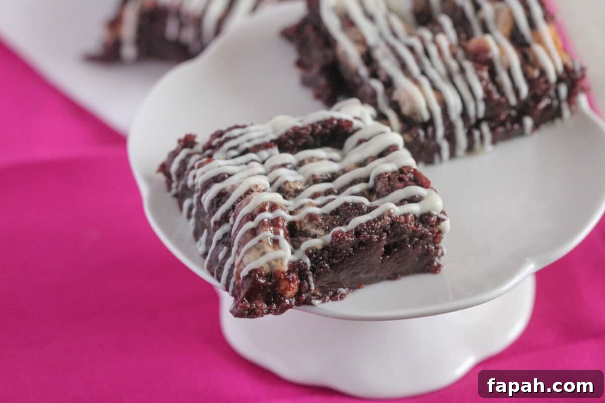 Decadent Caramel Pecan Brownies with Gooey Center 8 gooey pecan brownie square on cake stand