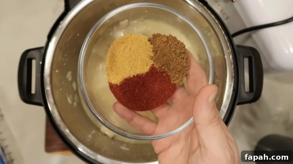 Adding Garam masala, seasoned salt, paprika to pot