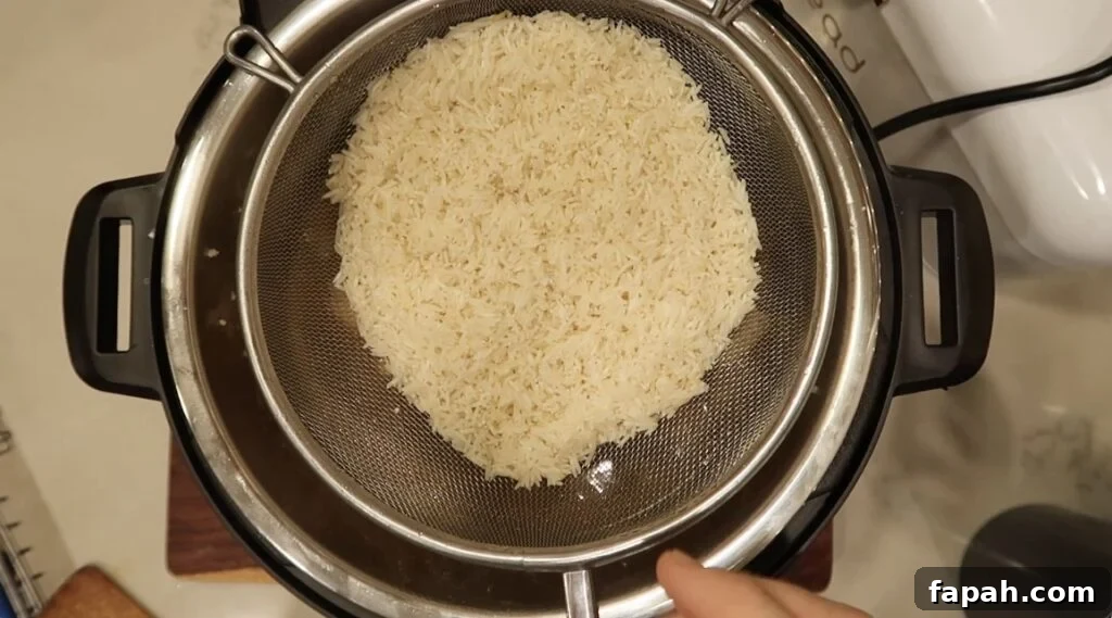 Adding rinsed basmati rice to pot