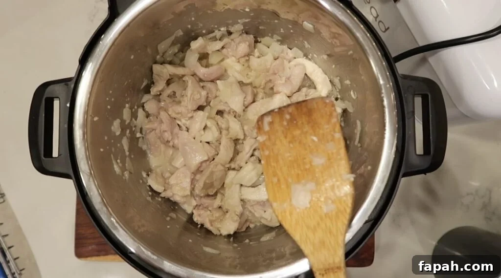 Sautéing the chicken in everything until pinkish-white in color.