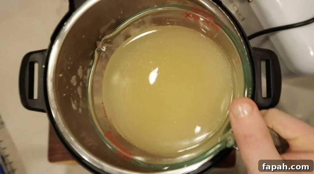 Adding broth to pot