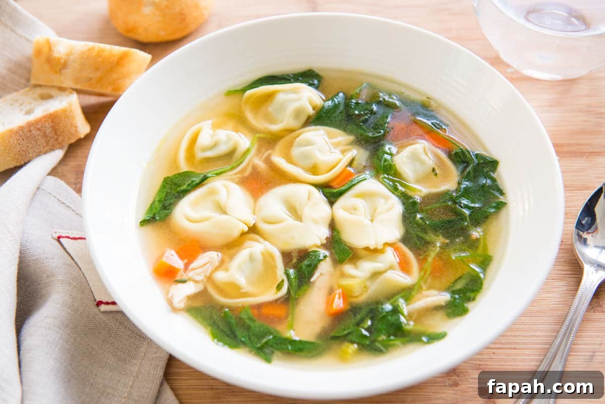 Creamy Spinach Tortellini Soup Recipe for Cozy Weeknights 3 Chicken Spinach Tortellini Soup in White Bowl with Bread
