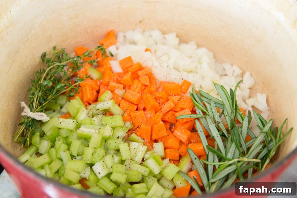 Creamy Spinach Tortellini Soup Recipe for Cozy Weeknights 5 Chopped celery, carrots, onions, and herbs in pot
