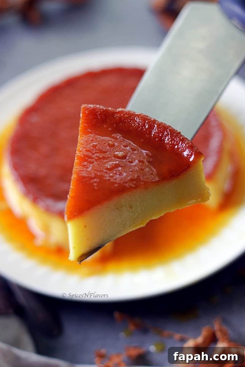 Eggless Caramel Bread Pudding Made in the Instant Pot 4 sliced piece of caramel bread pudding held in a knife showing the glossy and smooth texture