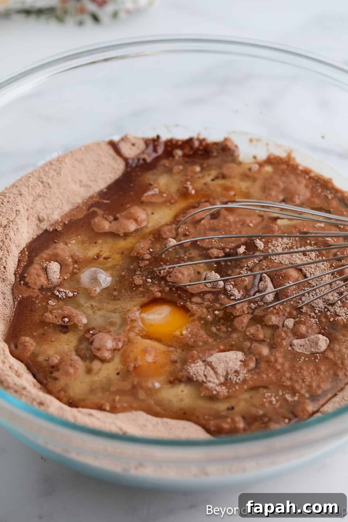 Moist Buttermilk Chocolate Cake Recipe for Rich Chocolate Flavor 5 Mixing eggs and oil into a chocolate batter.
