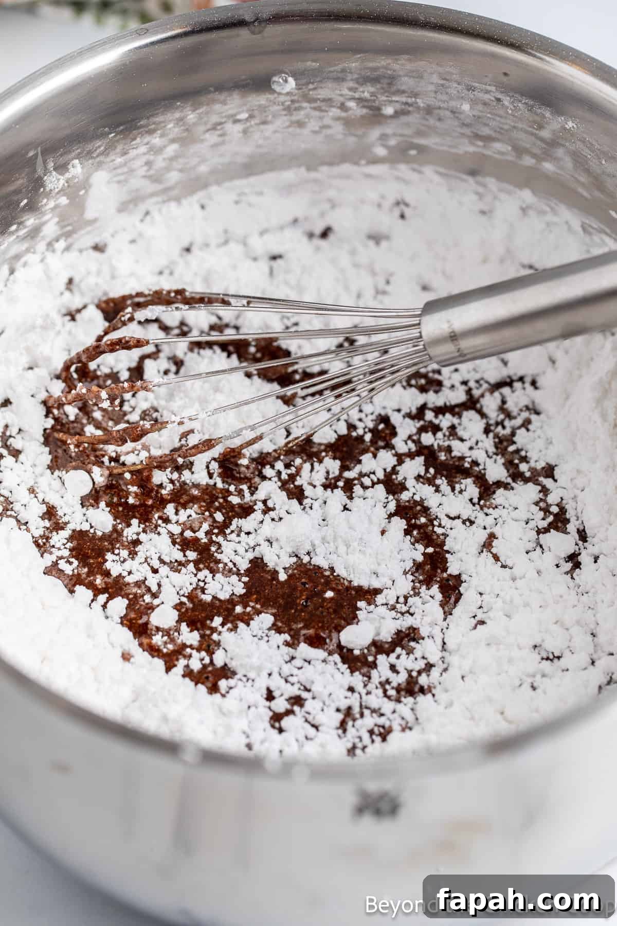 Moist Buttermilk Chocolate Cake Recipe for Rich Chocolate Flavor 9 Mixing powdered sugar into butter and cocoa powder.