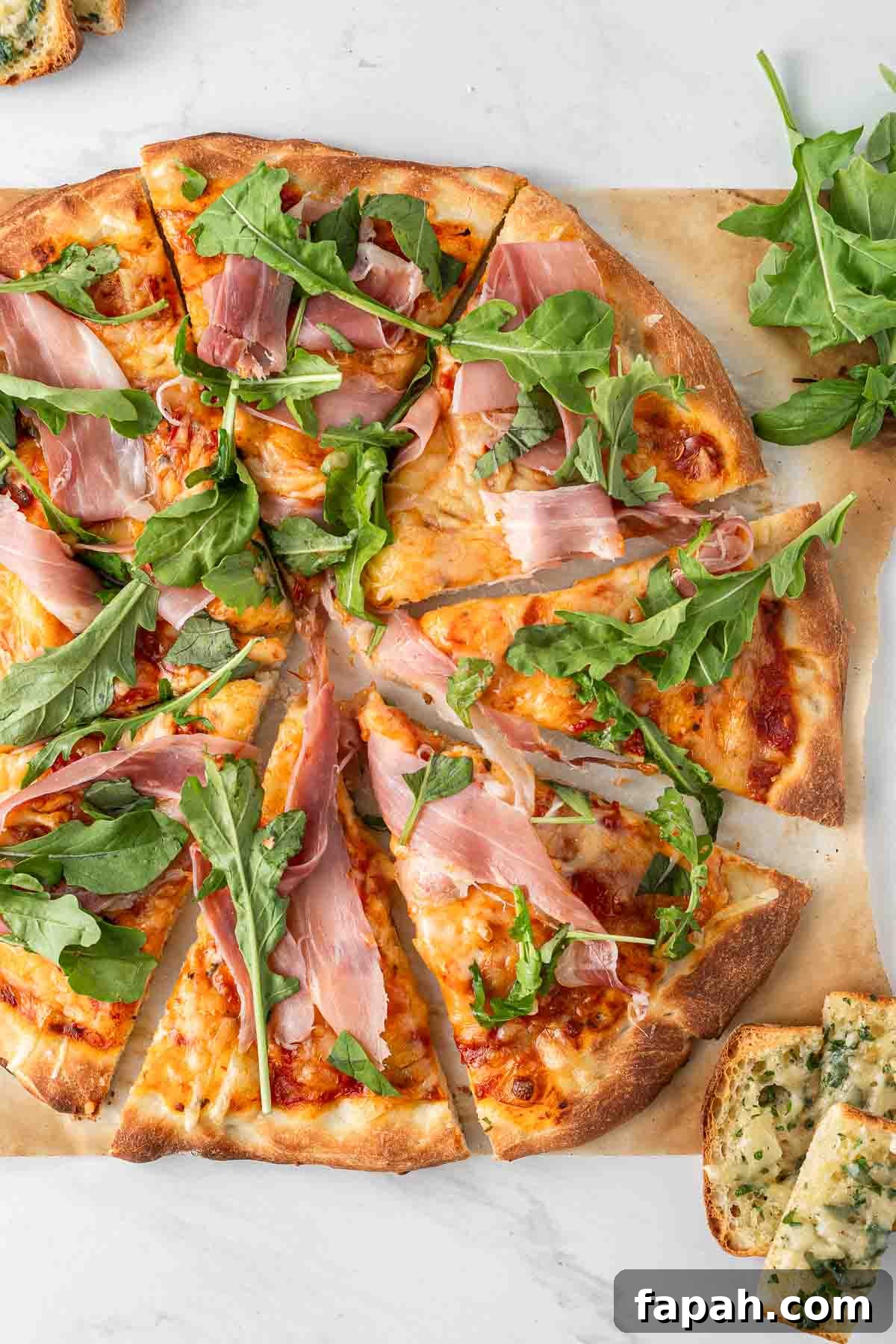 Close up of sliced whole pizza.