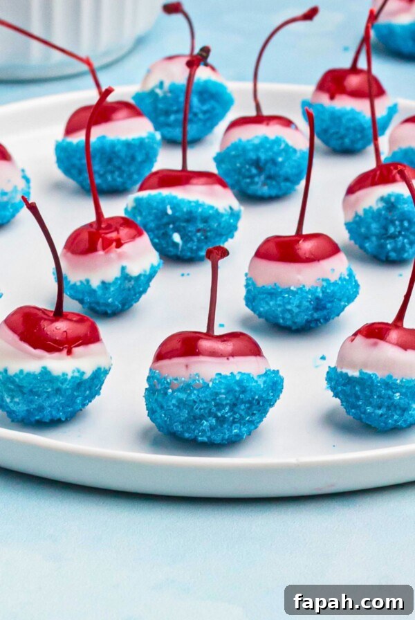 Baked Brie with Honey and Pecans: Warm Party Appetizer 14 Cherries coated in white chocolate, then dipped in blue sanding sugar, on a white round plate.