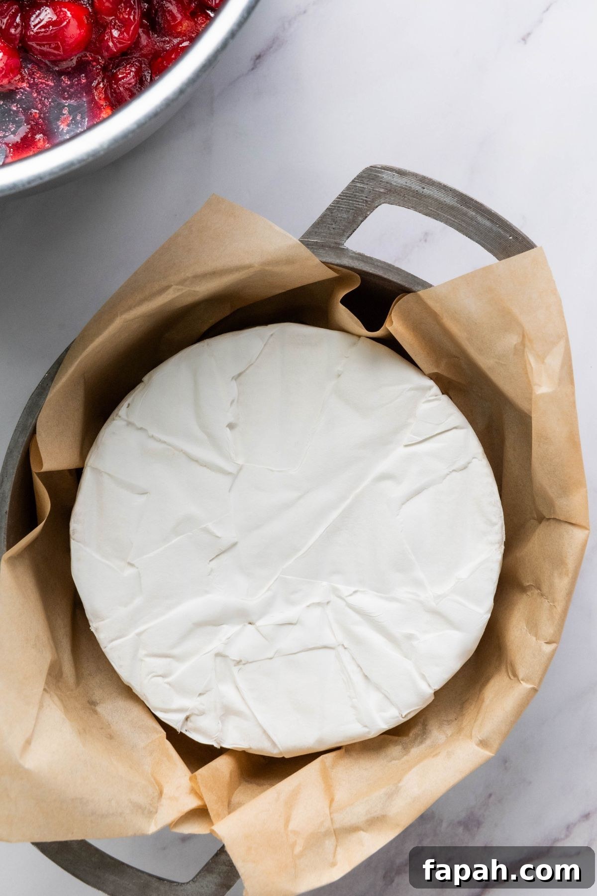 Baked Brie with Honey and Pecans: Warm Party Appetizer 4 Brie cheese tucked into a baking pan.