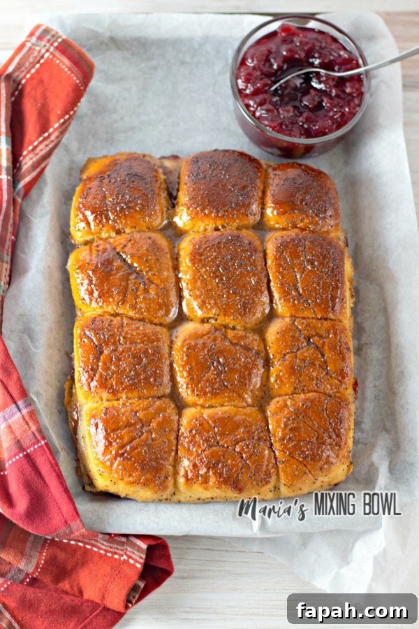 rolls and cranberry sauce , red naplkin