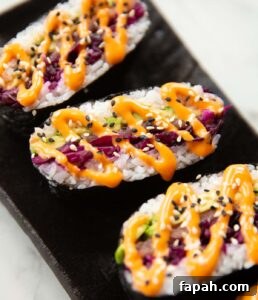 sushi sandwich close up shot of 3 sushi sandwiches on serving plate