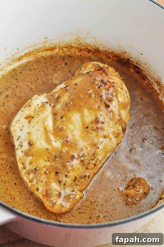 Chicken cooking in buttery garlic sauce